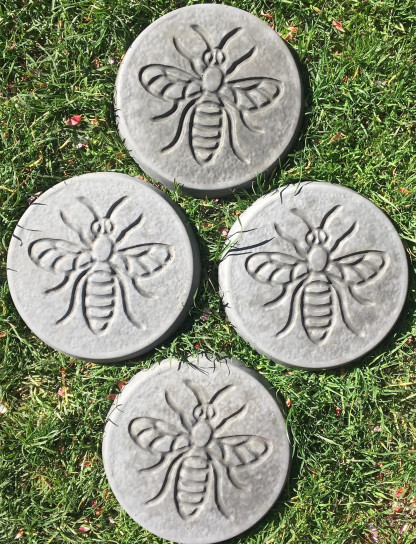 Pack of 4 bee design stepping stones in a charcoal colour.