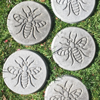 Pack of 5 bee design stepping stones in a charcoal colour.