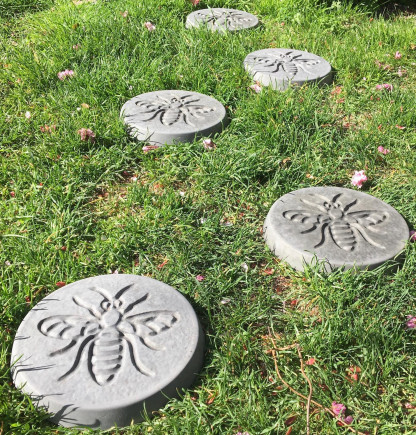 Pack of 6 bee design stepping stones in a charcoal colour.