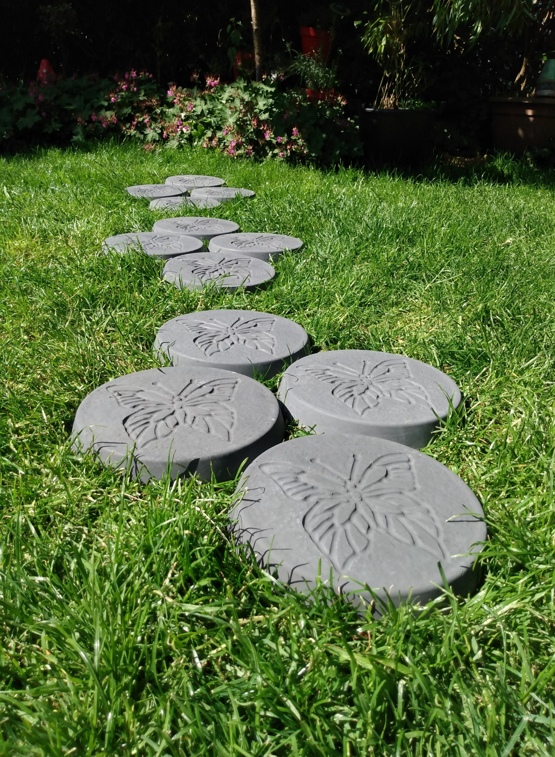 concrete stepping stones laid in groups of four to create a bigger surface area