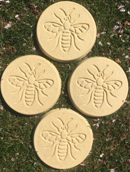 Pack of 4 bee design stepping stones in a buff colour.