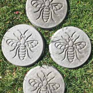 Pack of 4 bee design stepping stones in a charcoal colour.